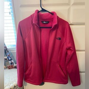 Pink north face jacket with fuzzy warm inside and pockets that zip up!